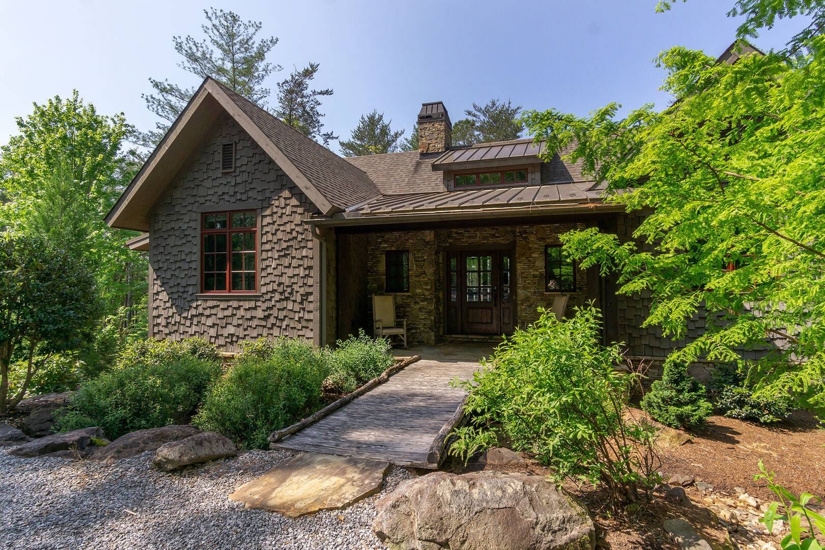 Rustic cottage with lush greenery.