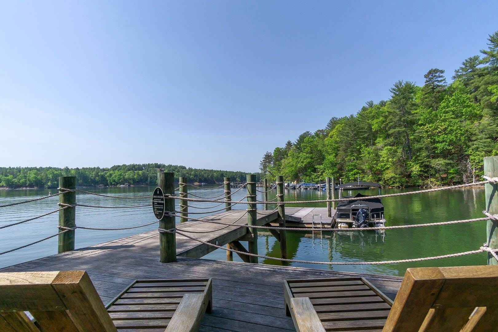 Lakeside dock with wooden chairs.