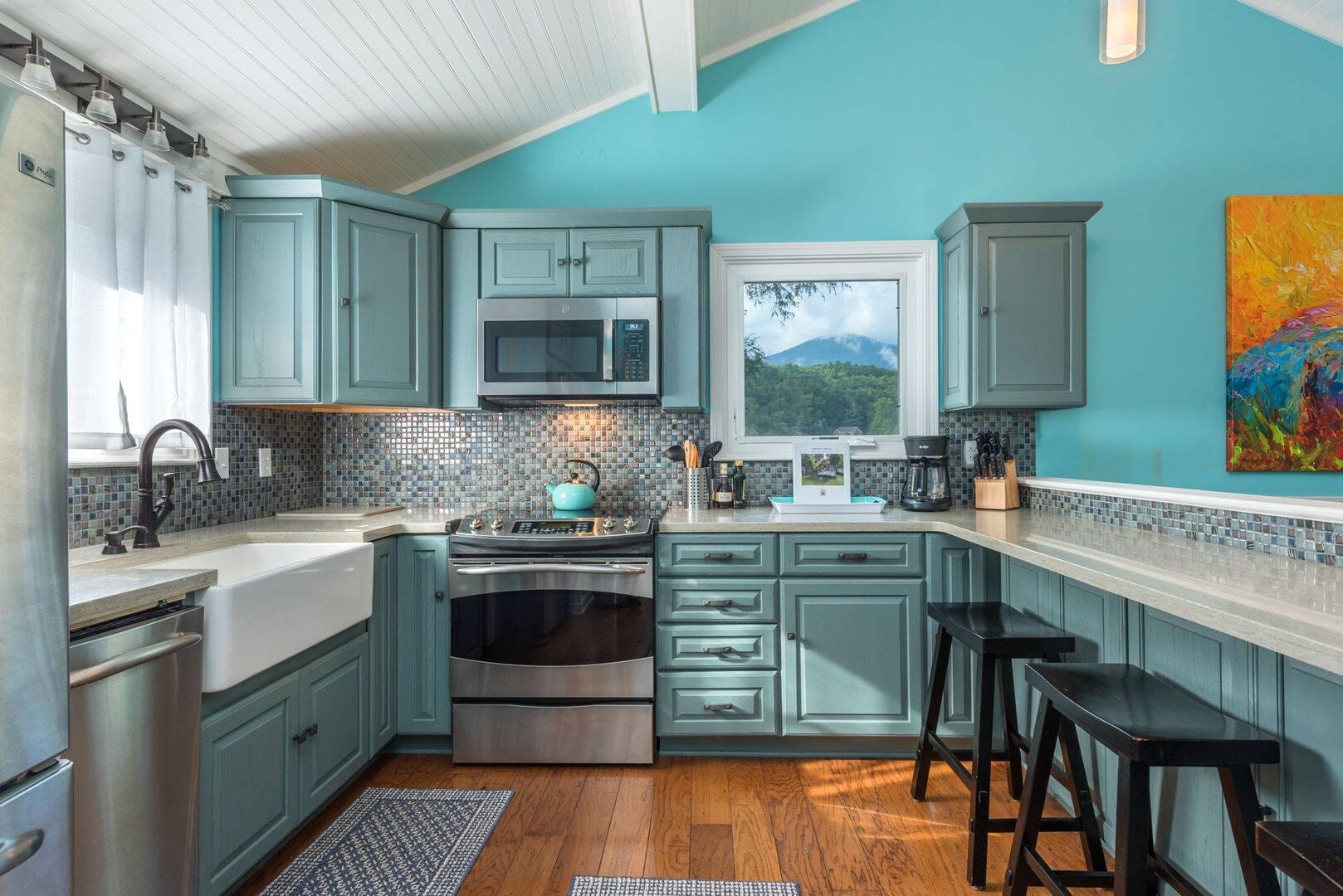 Turquoise kitchen with modern appliances.