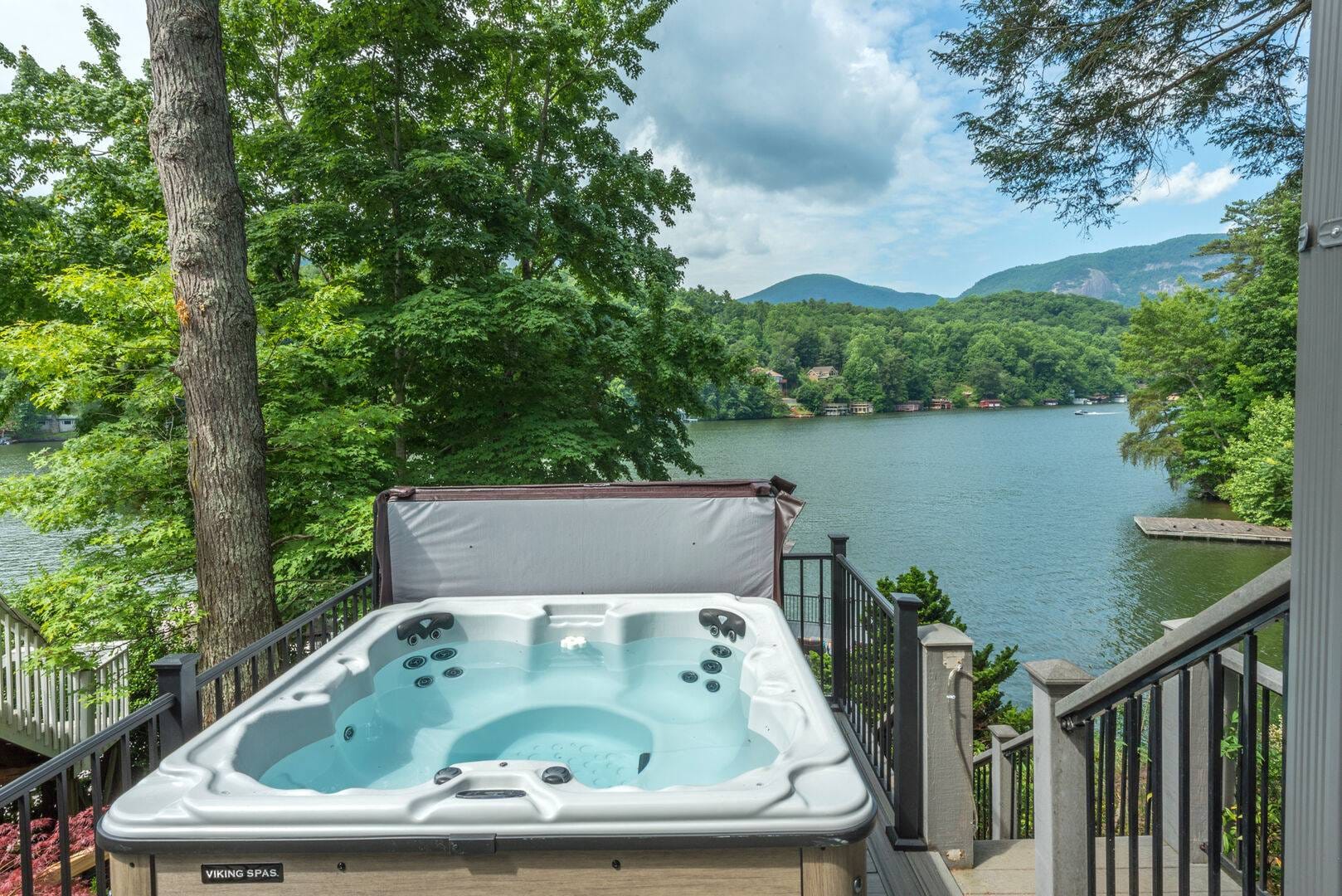 Hot tub overlooking scenic lake view.