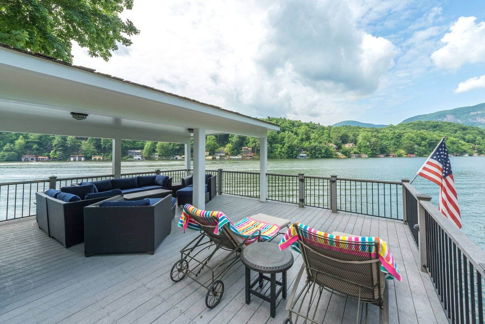 Deck overlooking lake with patio furniture.