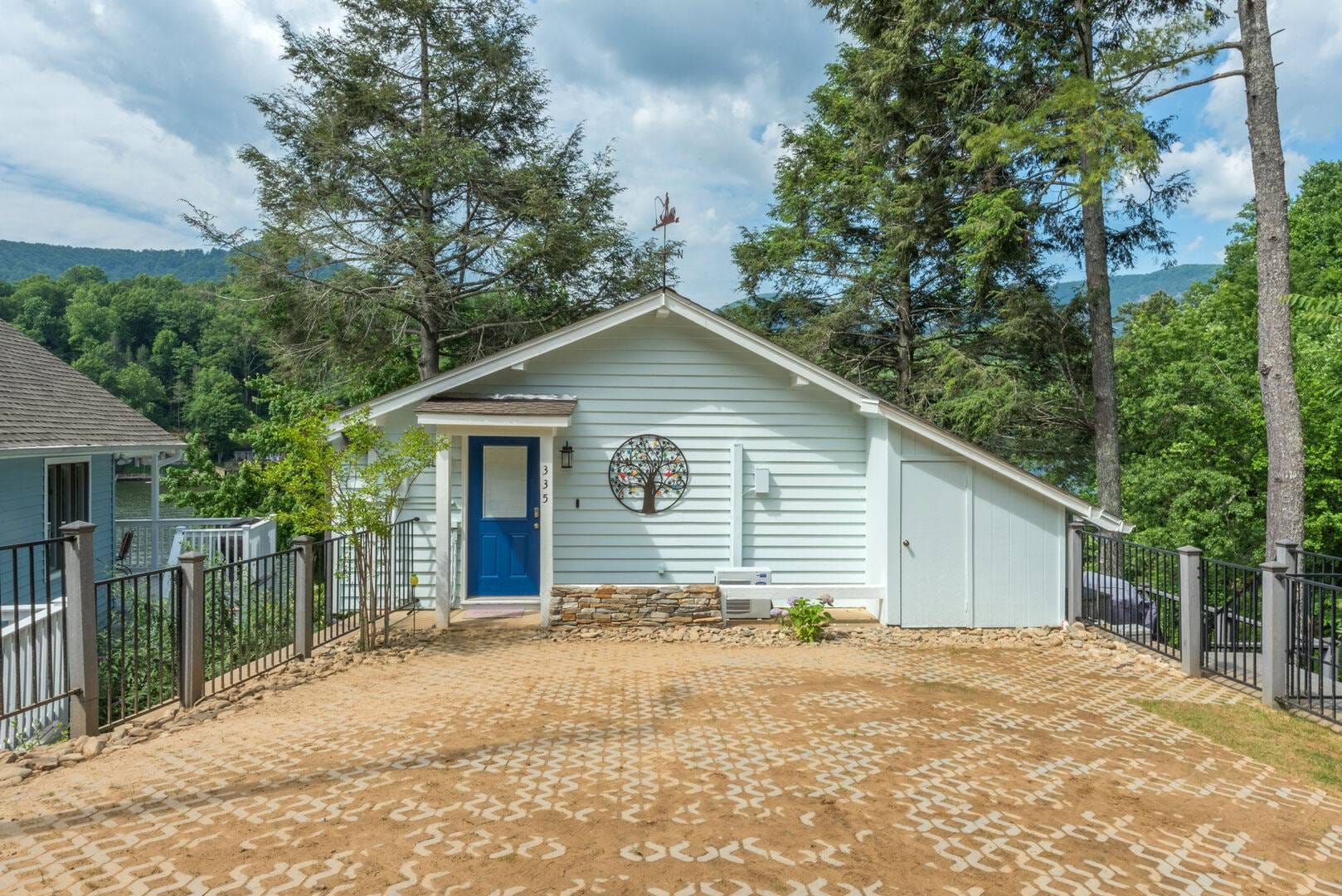 House with blue door, driveway.