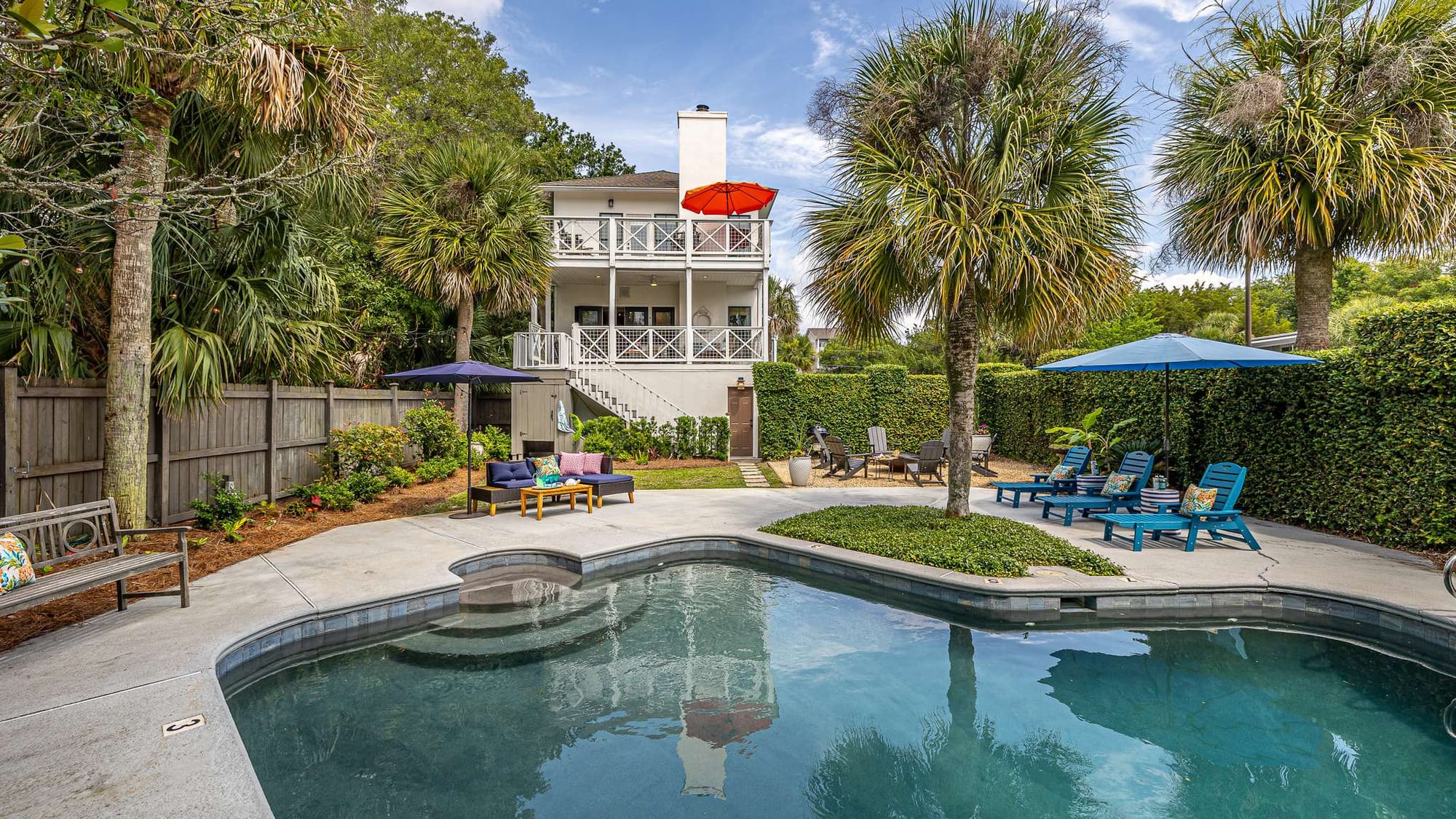 Backyard pool with seating area.