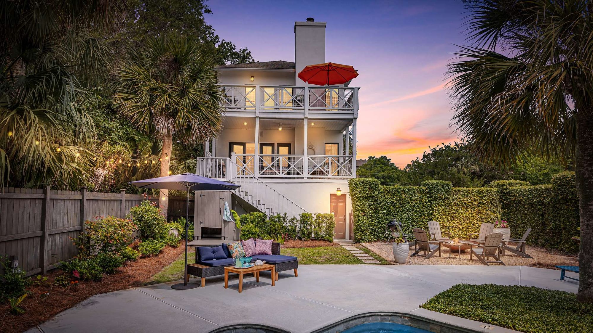 House with backyard, pool, and seating.