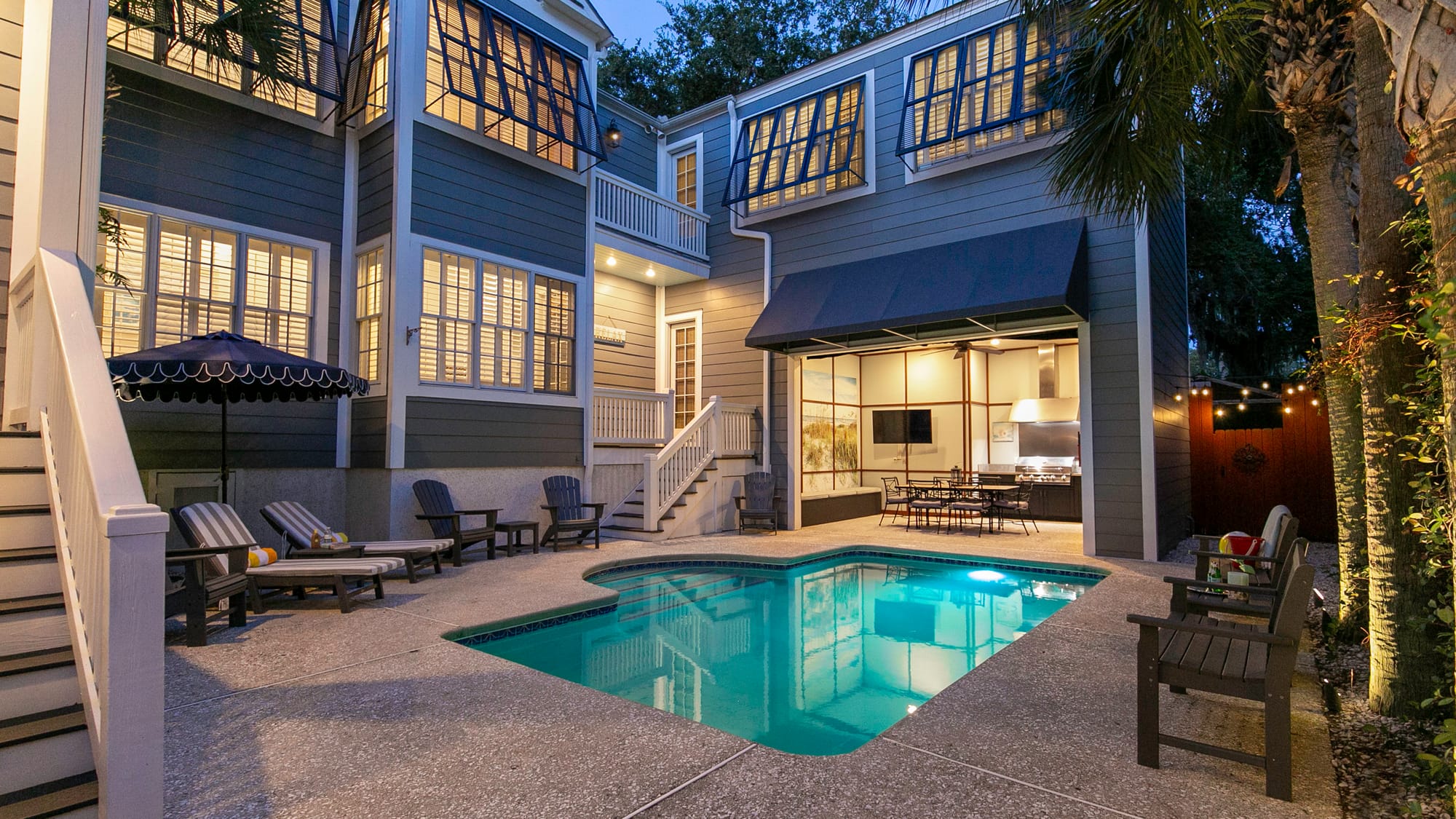 House with pool and patio furniture.