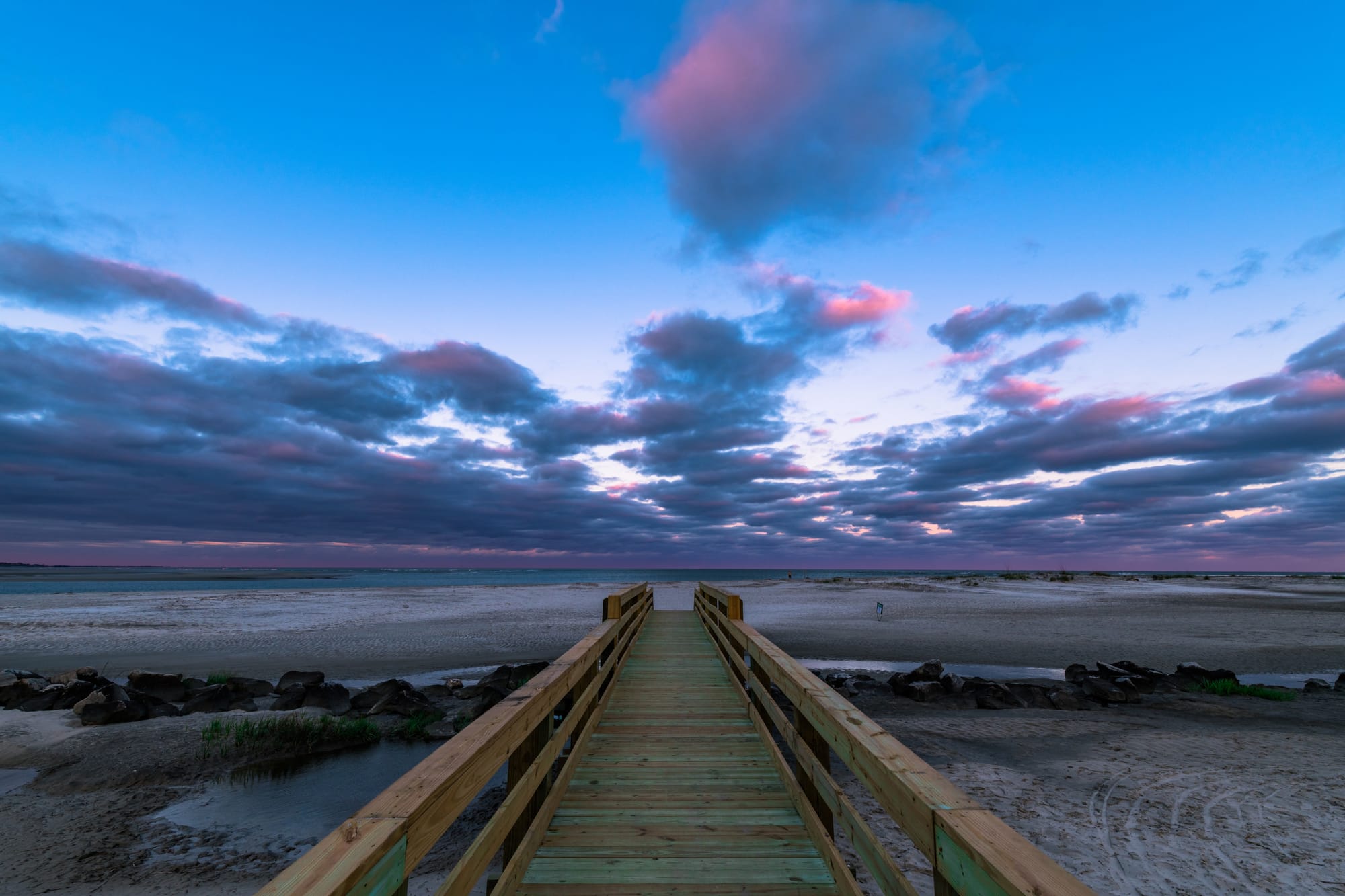 Wooden boardwalk leading to beach.