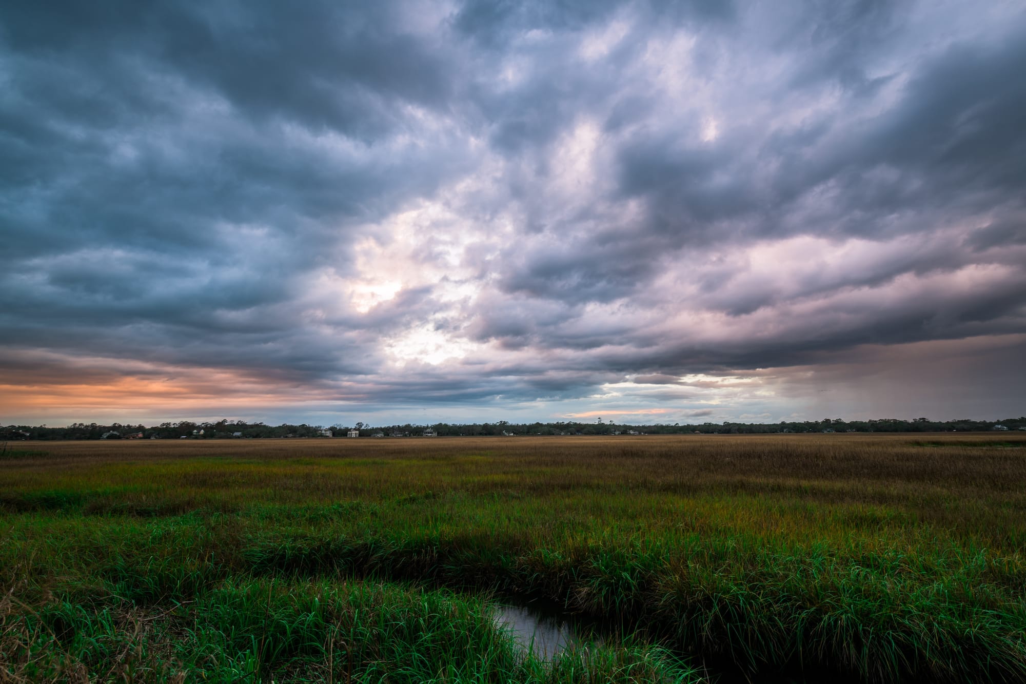 Field with dramatic cloudy sky.