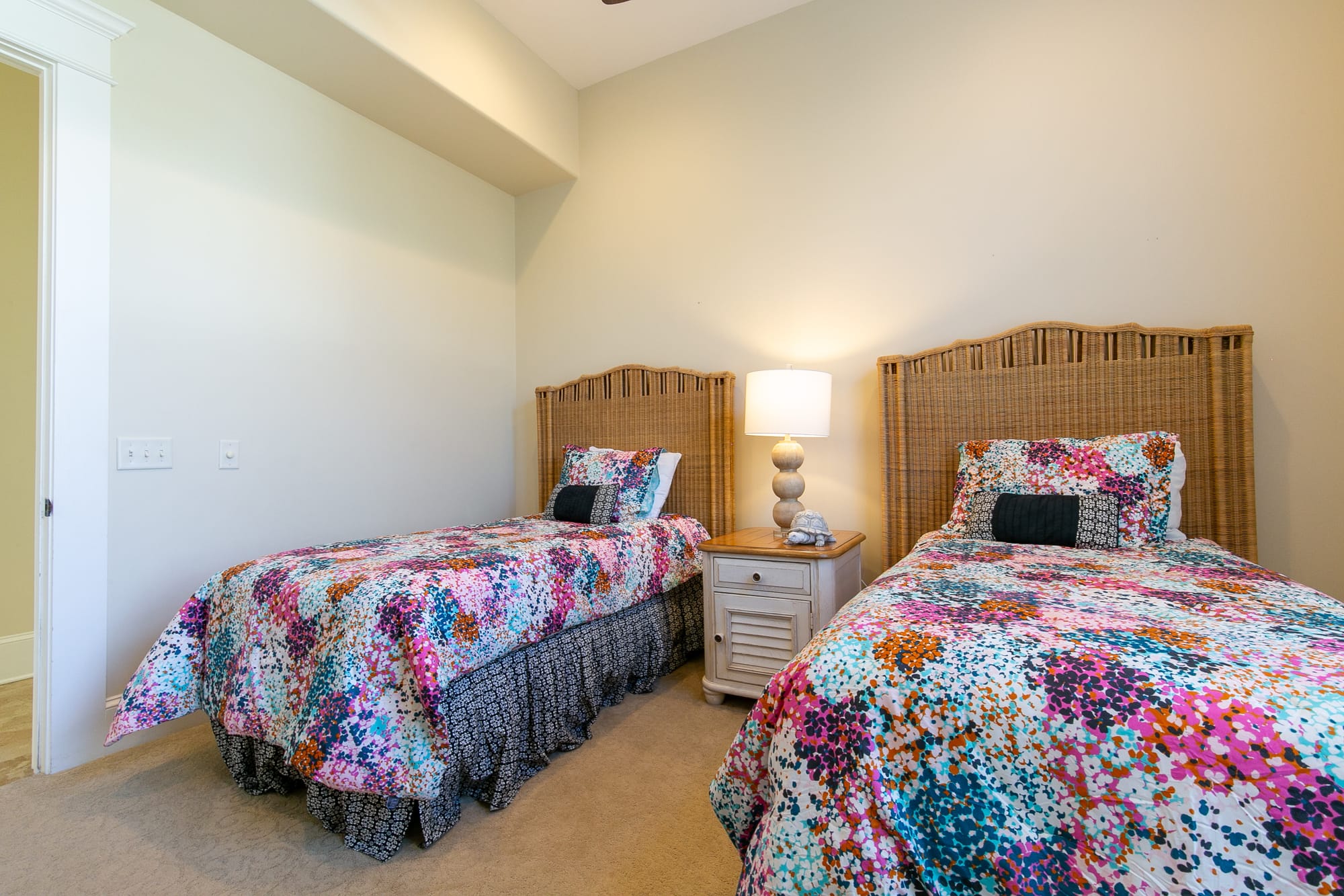 Two twin beds, floral bedding.