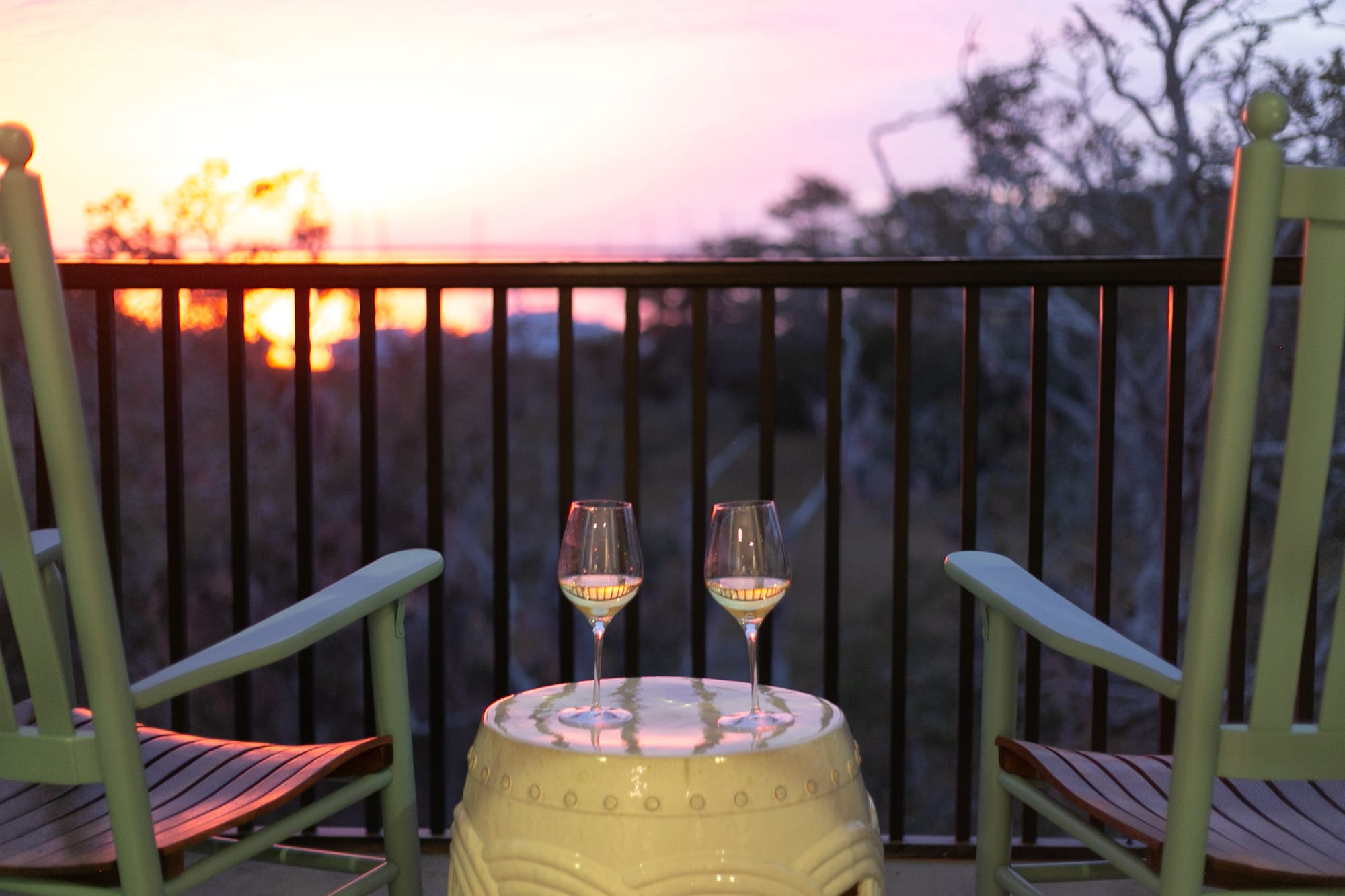 Two chairs with wine glasses.