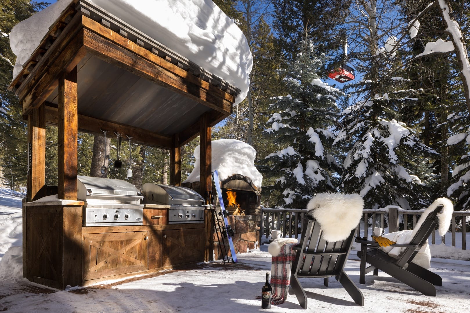 Snowy outdoor BBQ setup with fire.