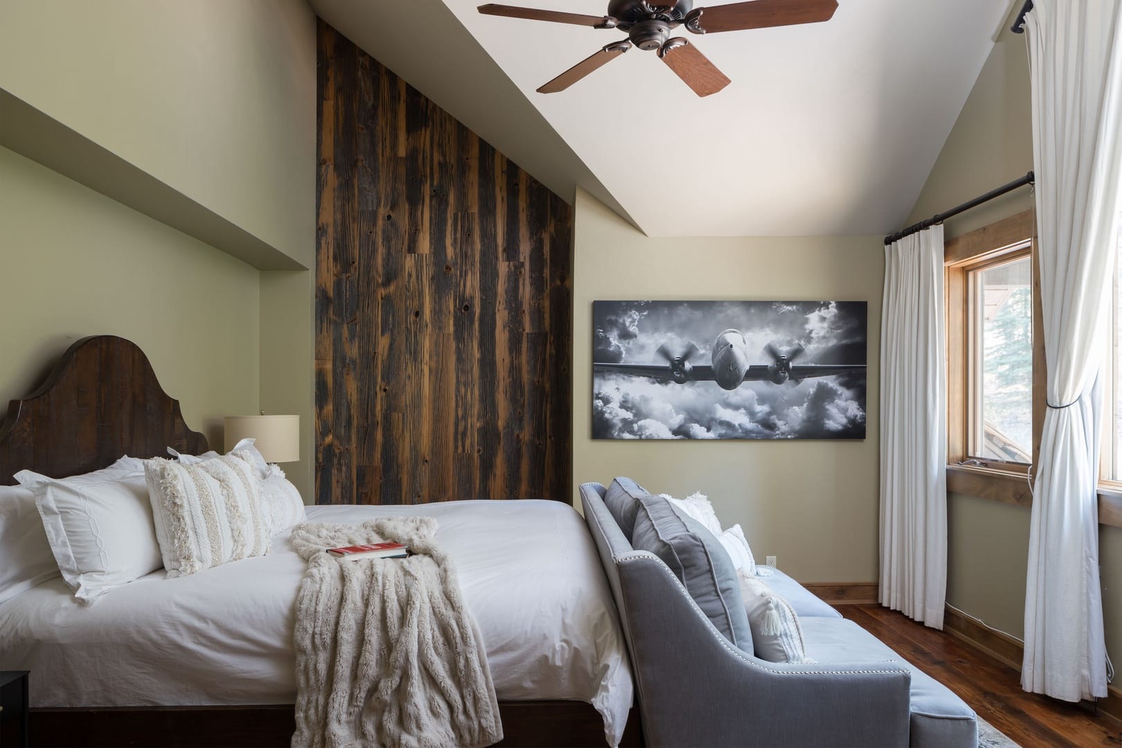 Modern bedroom with airplane artwork.