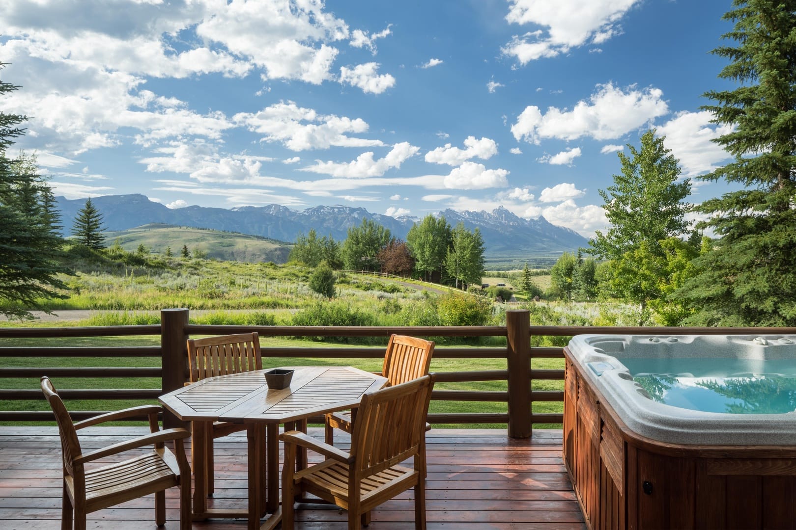 Deck with mountain view and hot tub.