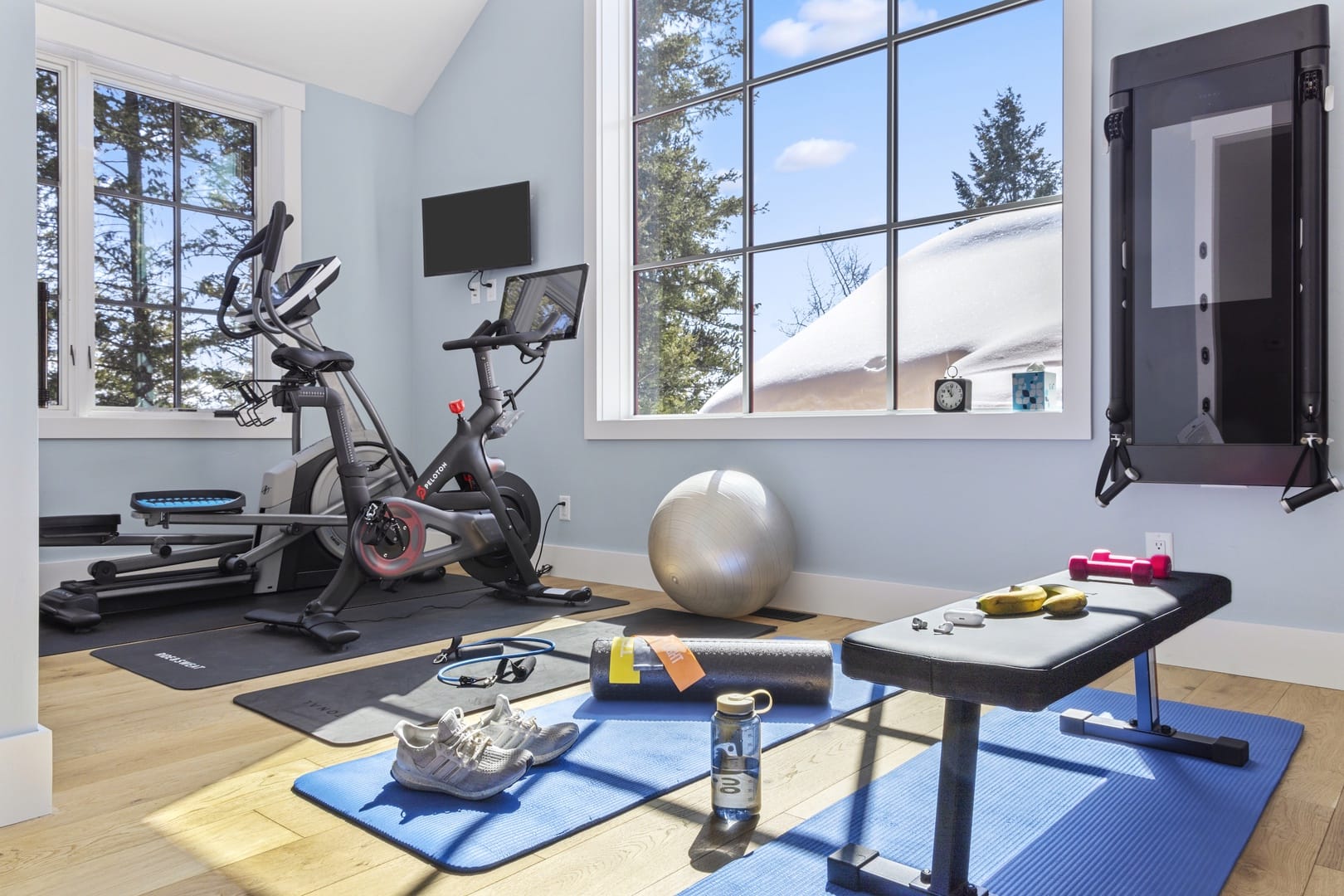 Modern home gym with exercise equipment.