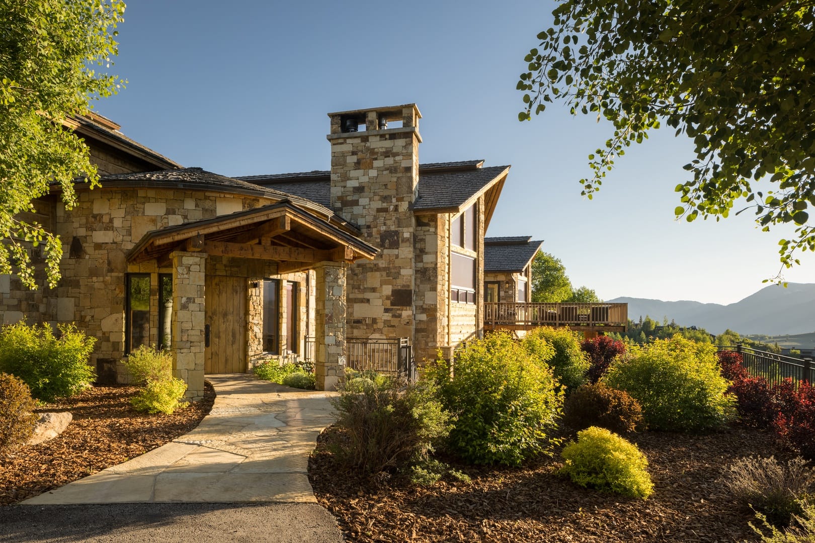 Stone house with lush garden.