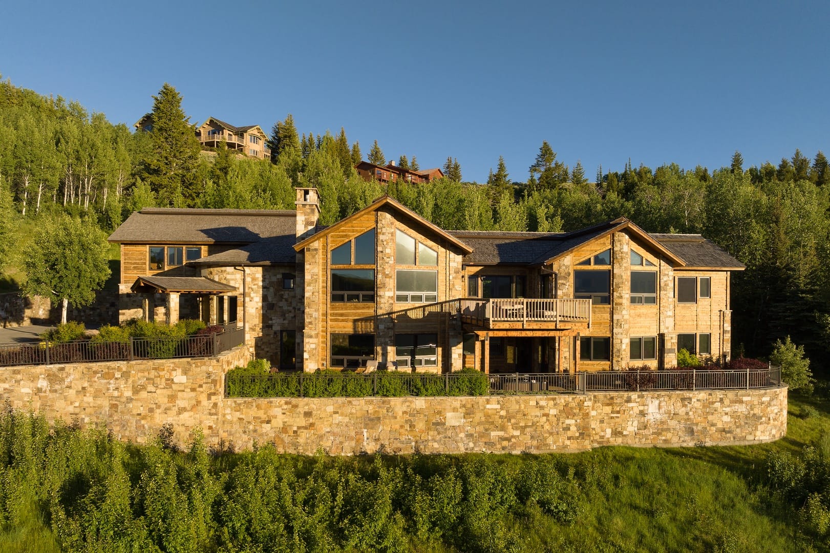 Large rustic house amidst trees.