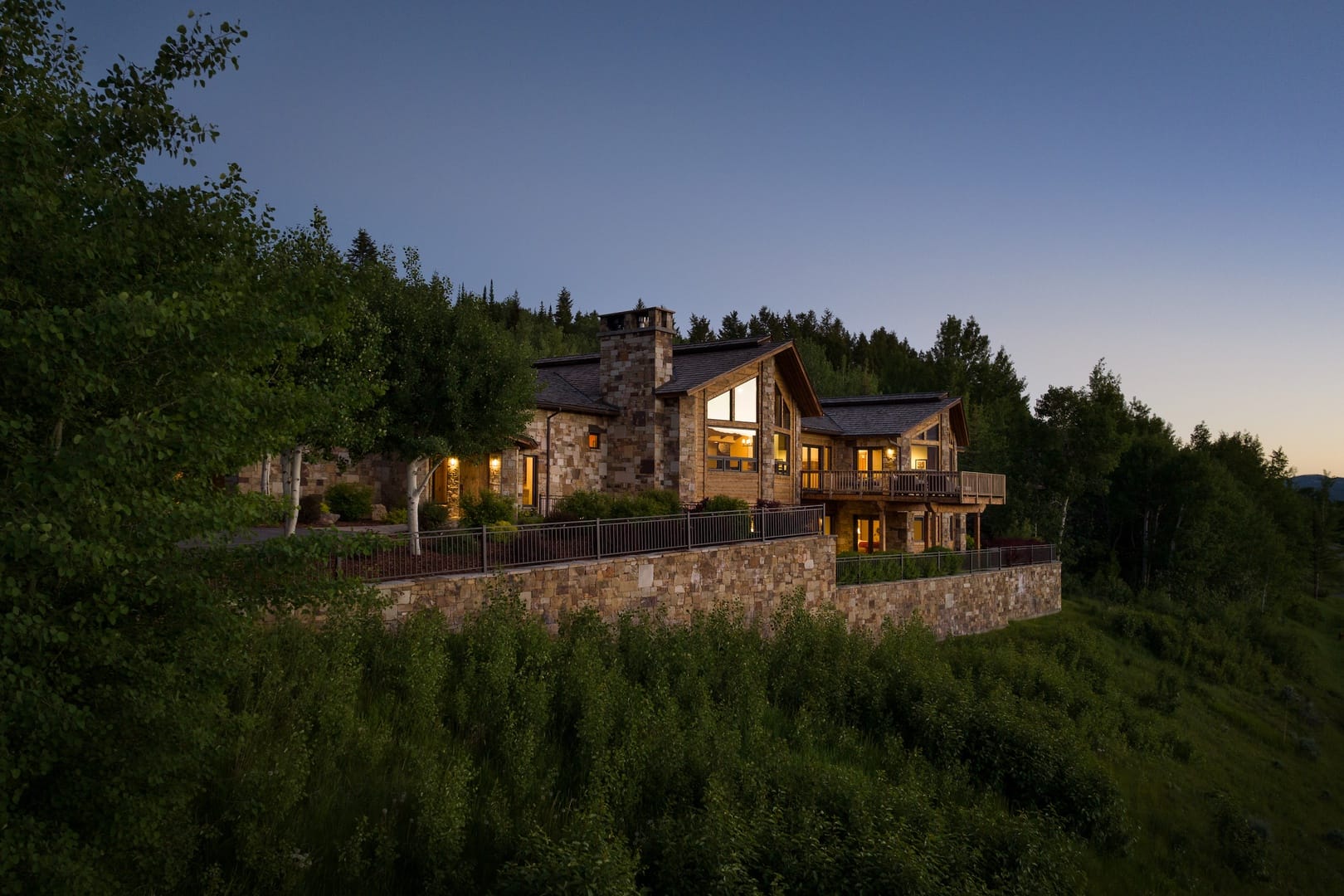 Luxury house on forested hillside.