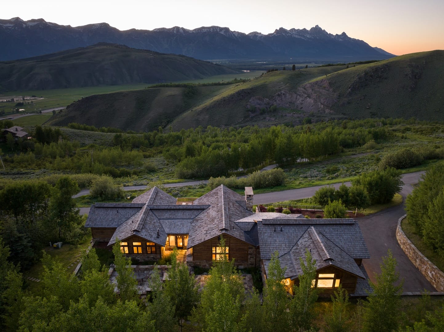 House in mountainous landscape at dusk.