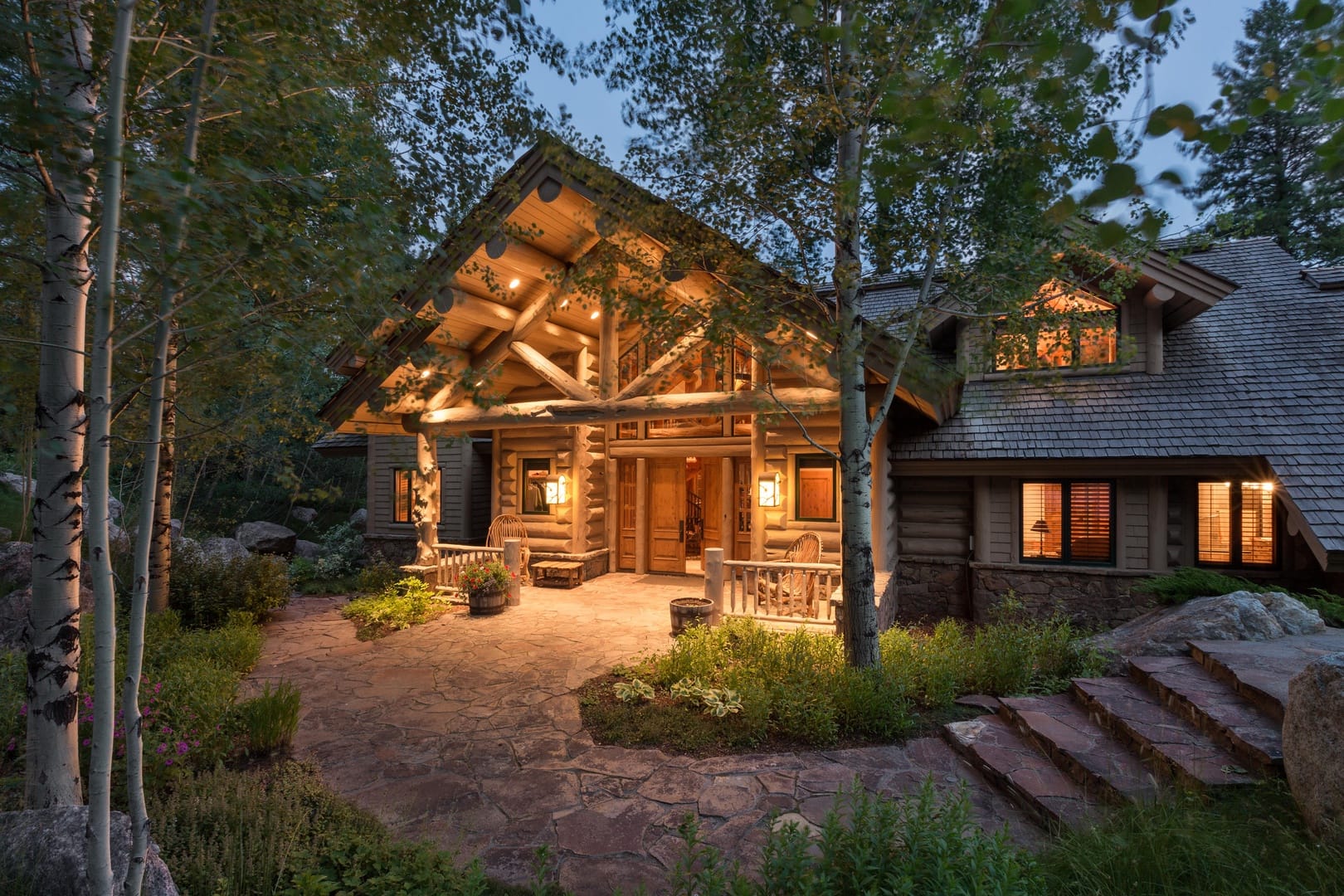 Cozy log cabin illuminated at dusk.