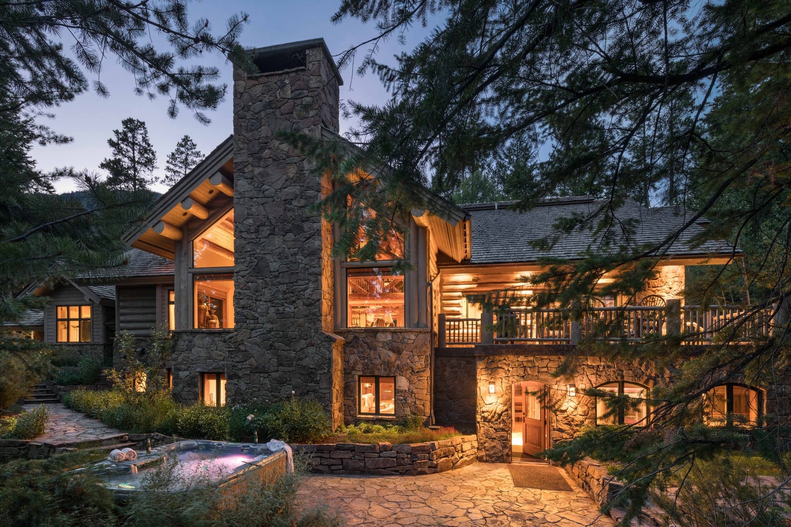 Rustic stone cabin with hot tub.