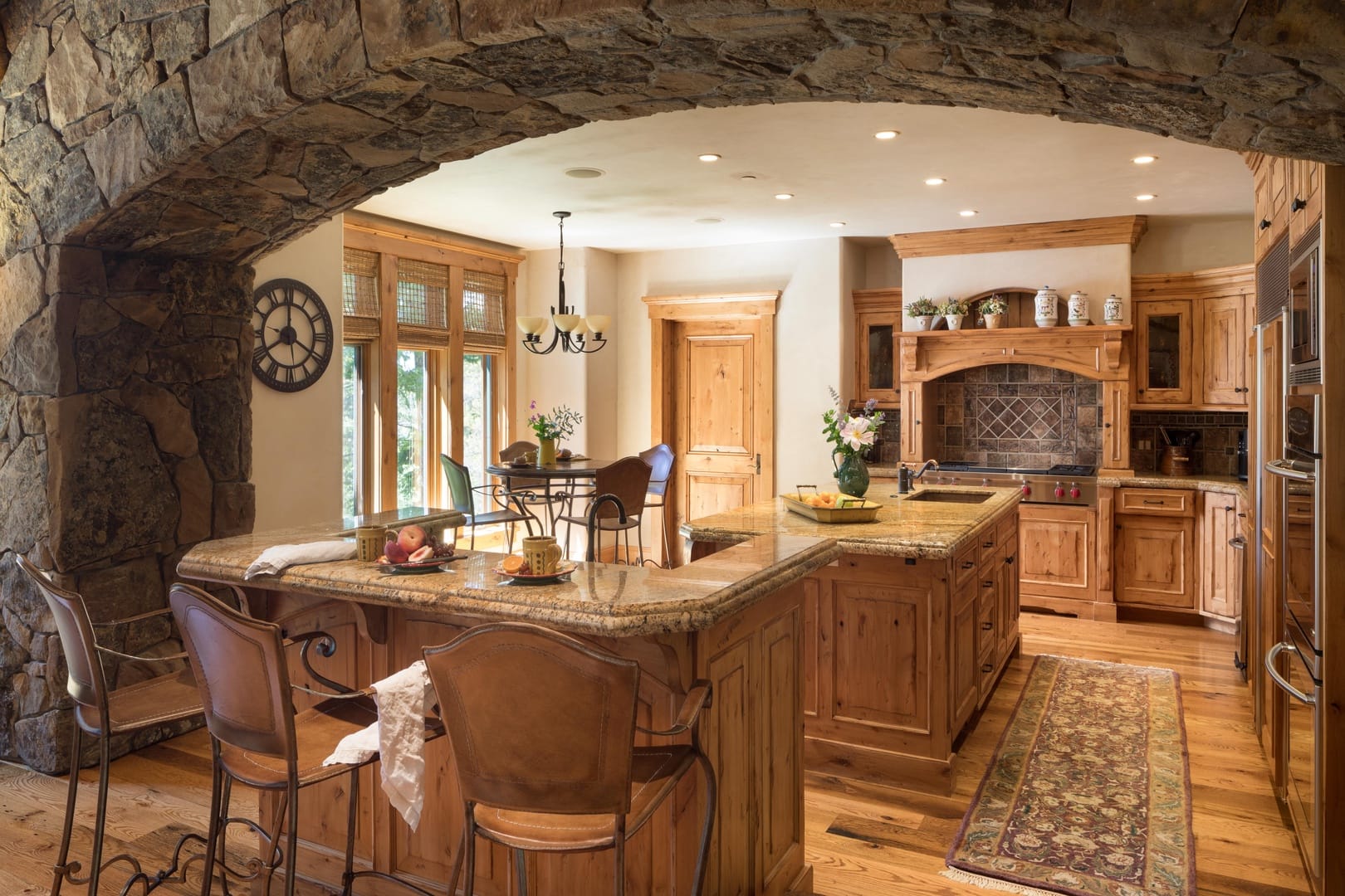 Rustic kitchen with stone archway.