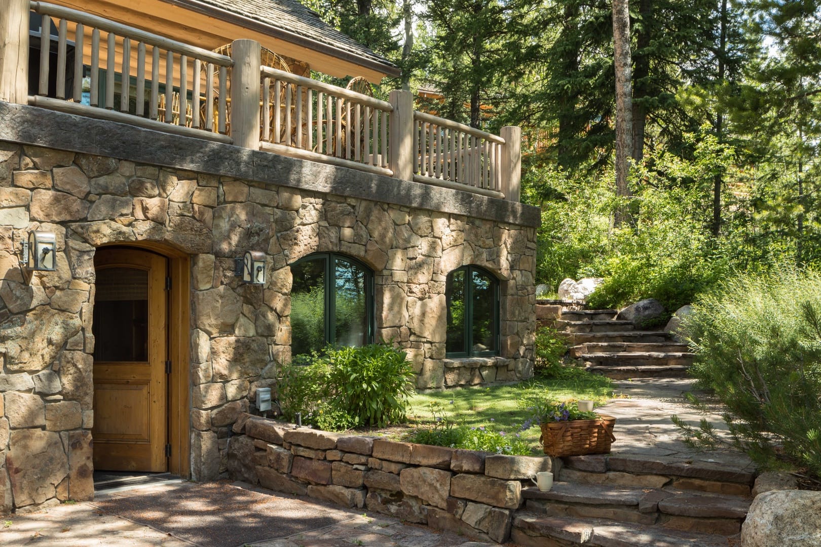 Rustic stone house in forest.