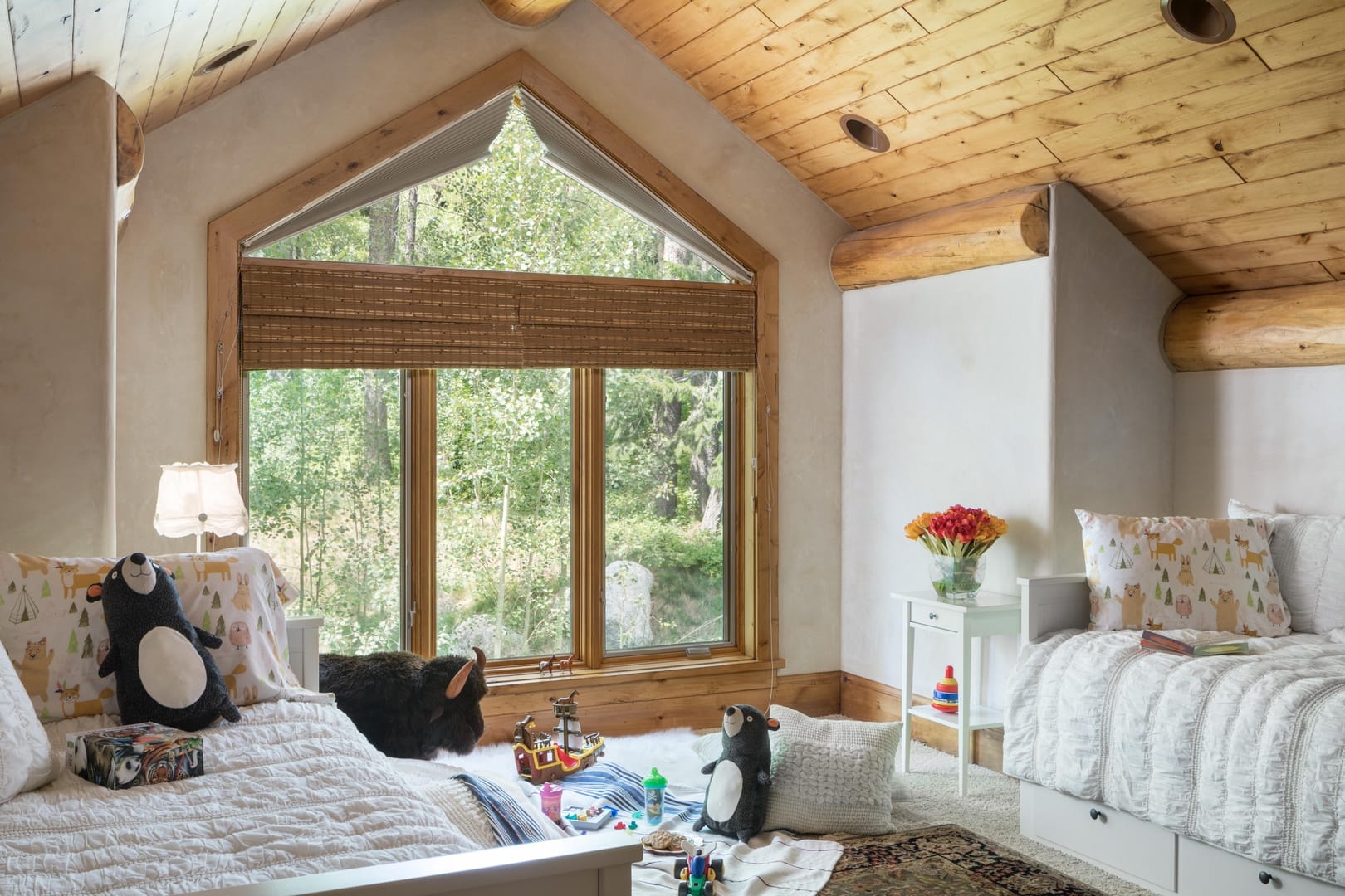 Cozy bedroom with stuffed animals.