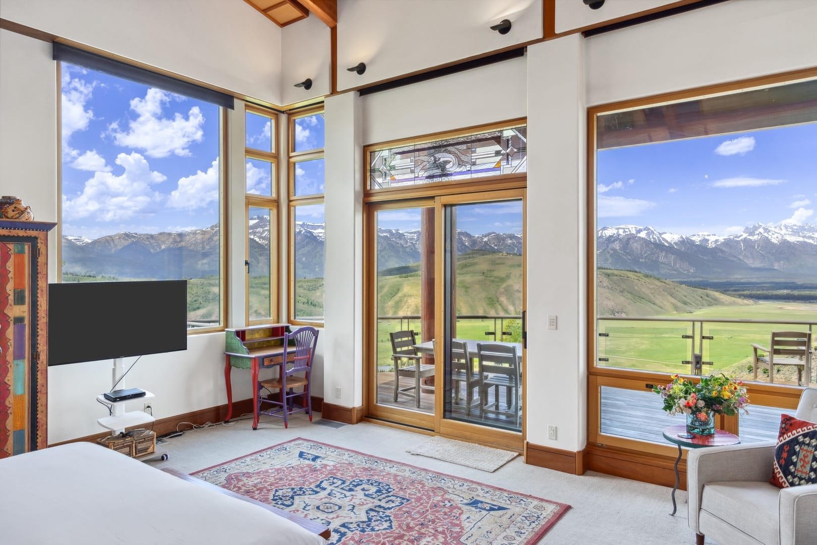 Room with mountain view windows.