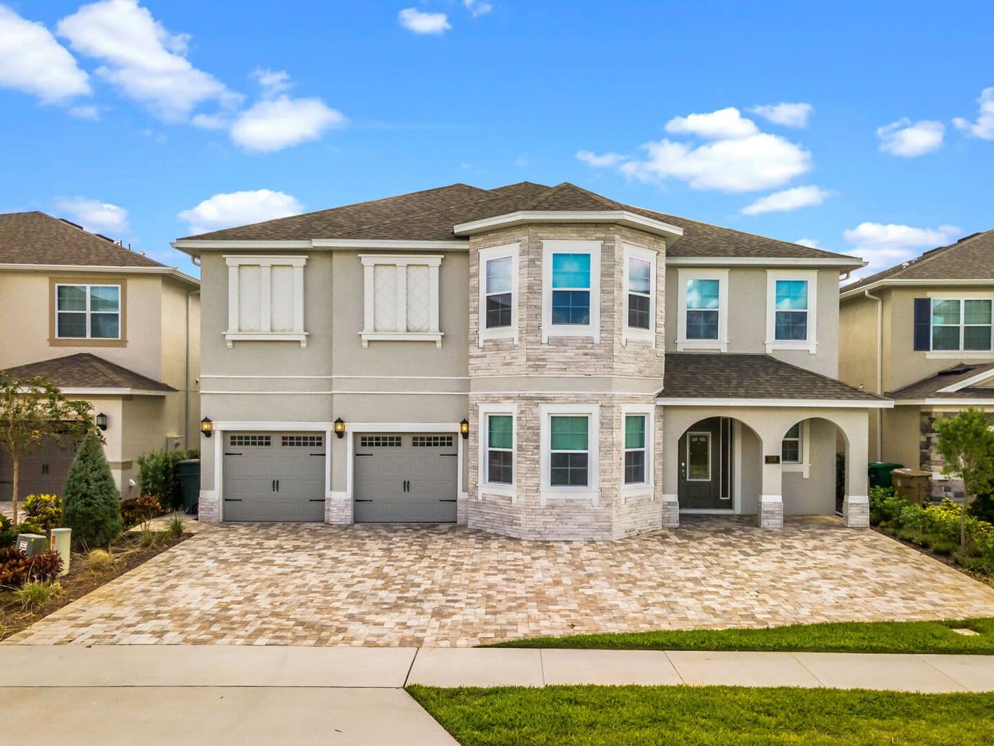 Two-story house with three garages.