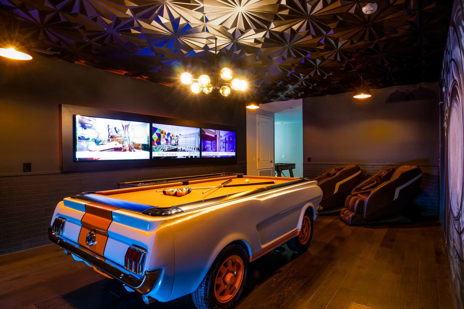 Car-themed pool table with screens.