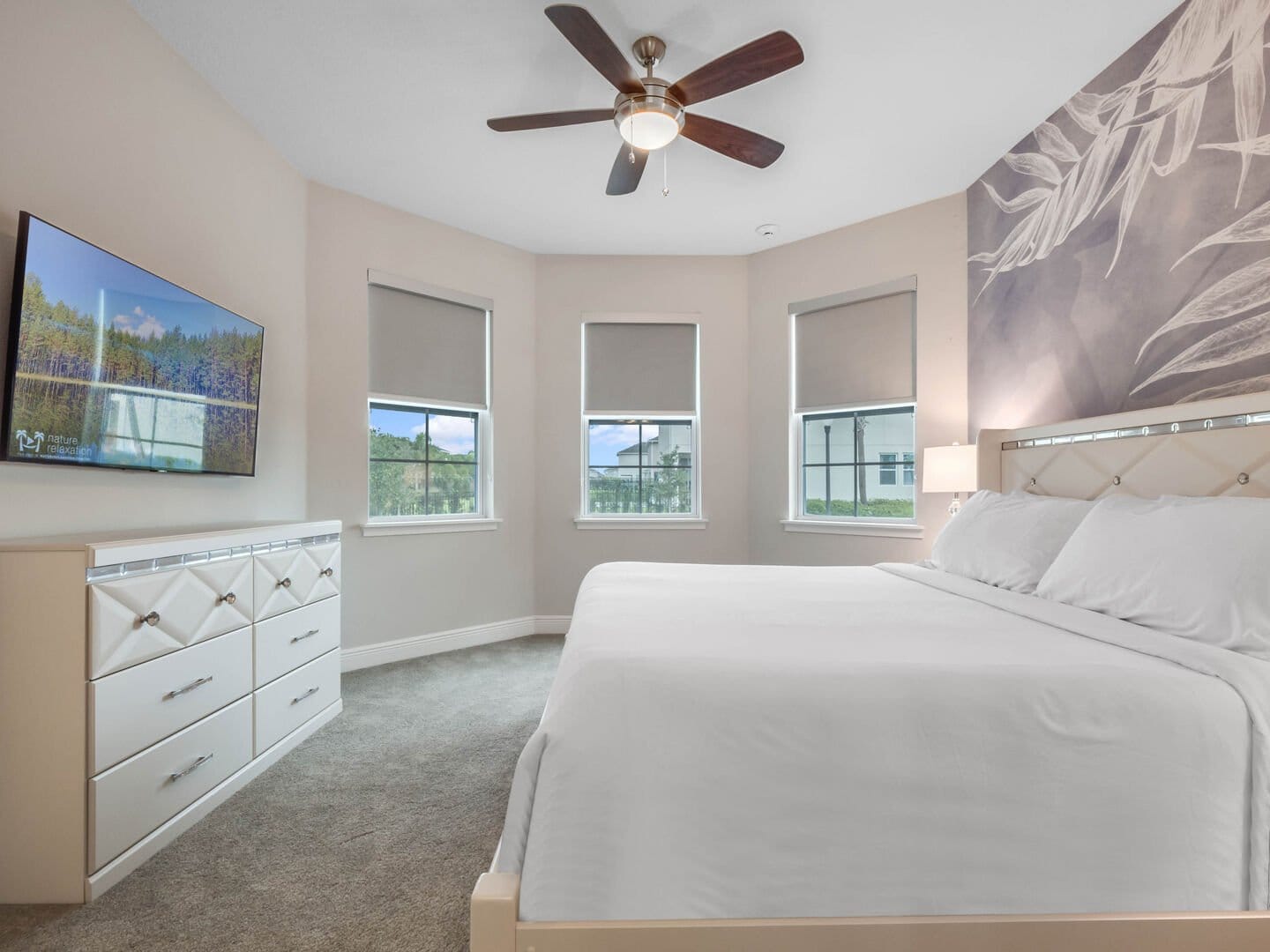 Bedroom with window, TV, bed.