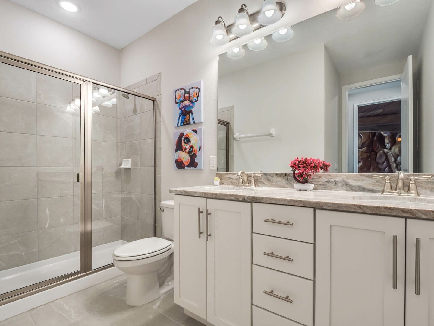 Modern bathroom with large mirror.