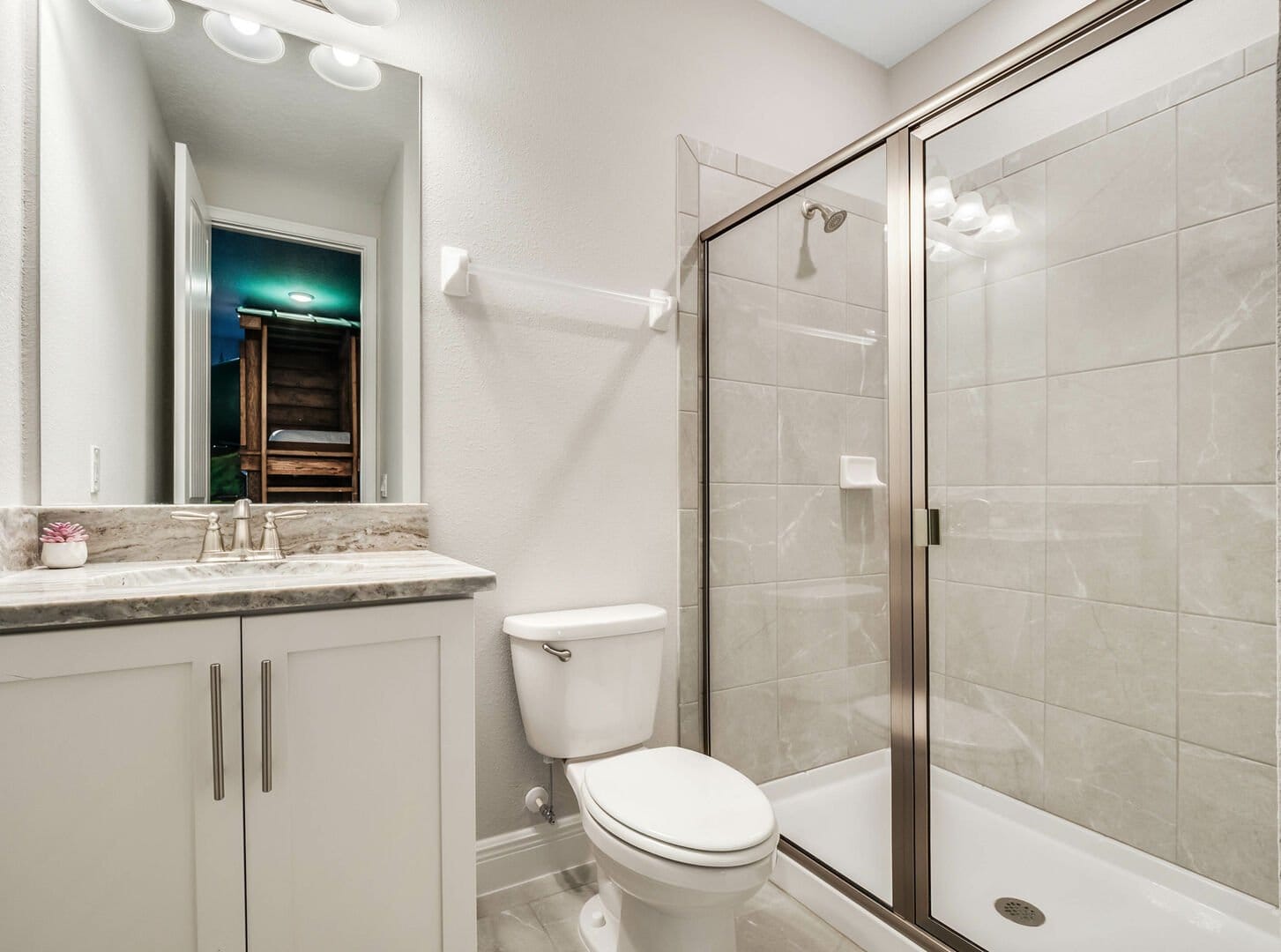 Modern bathroom with shower and toilet.