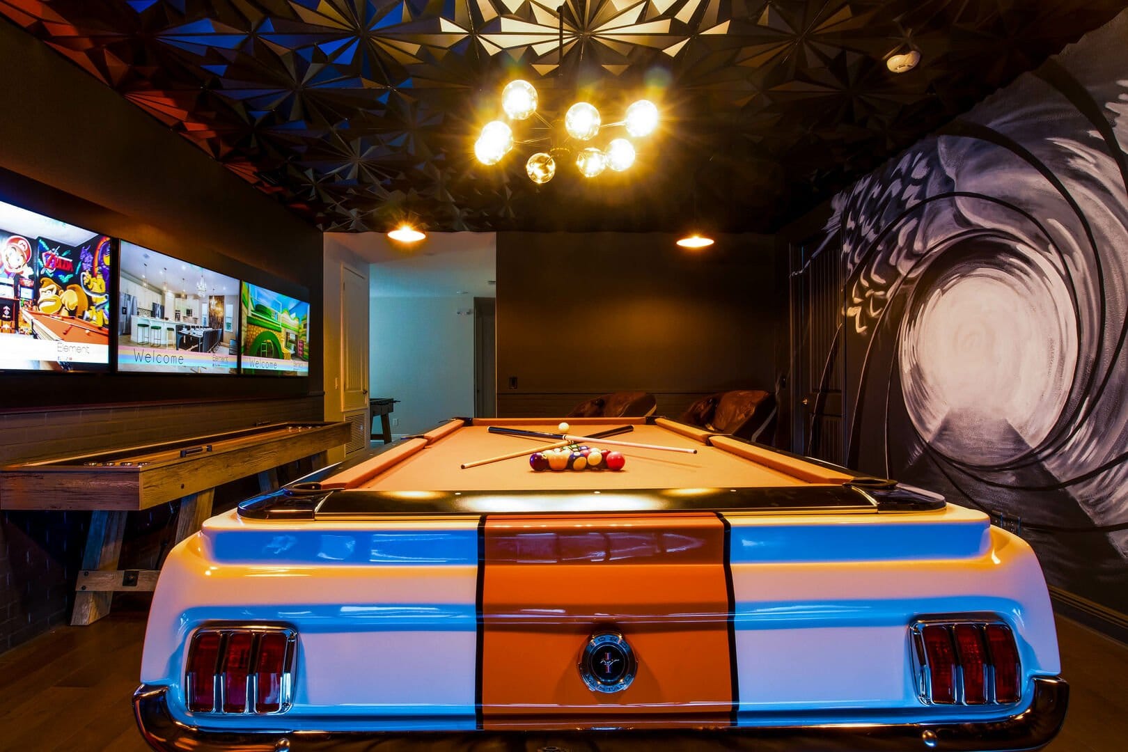 Billiards room with vintage car-themed table.