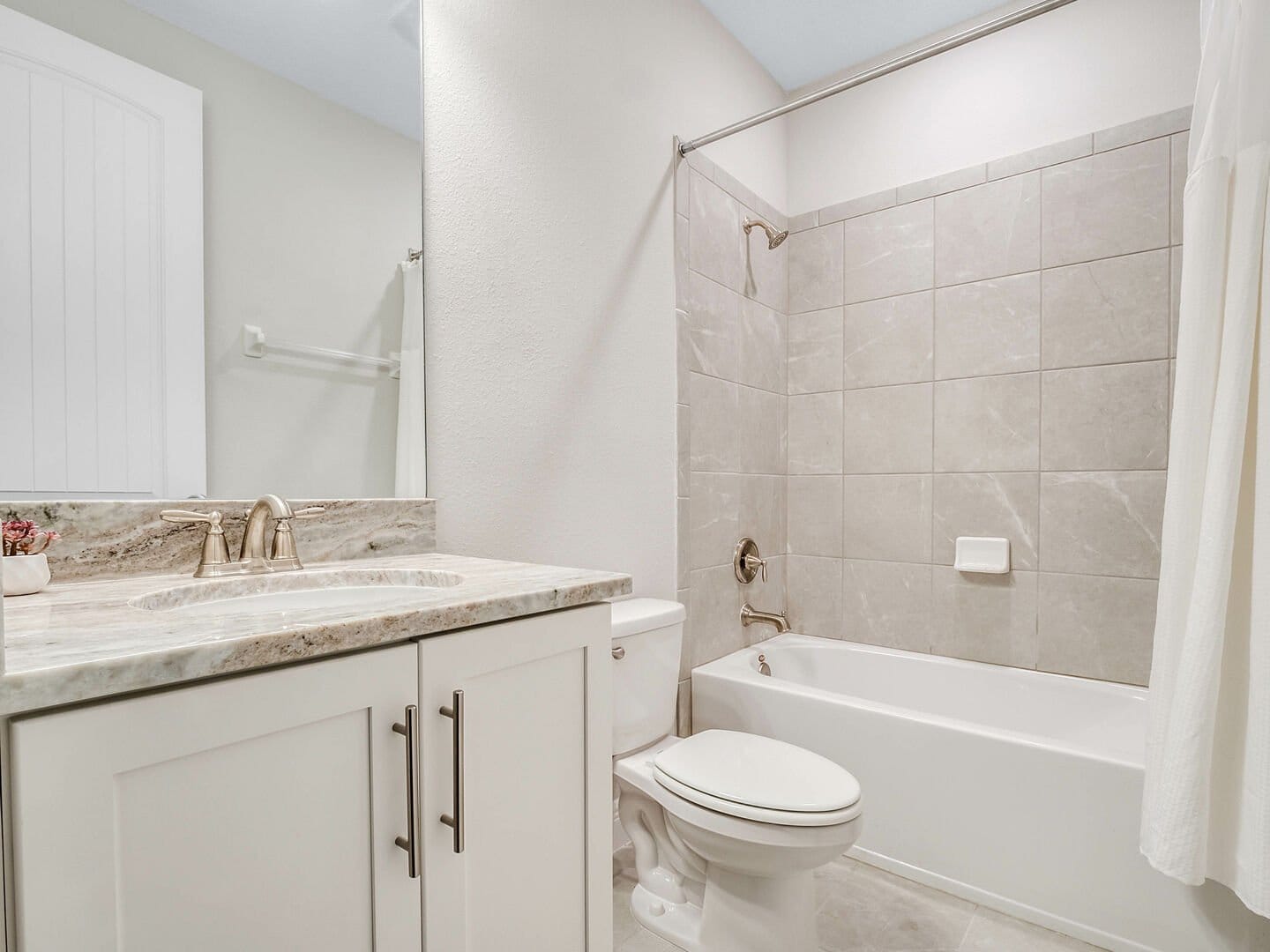 Modern bathroom with tub and vanity.