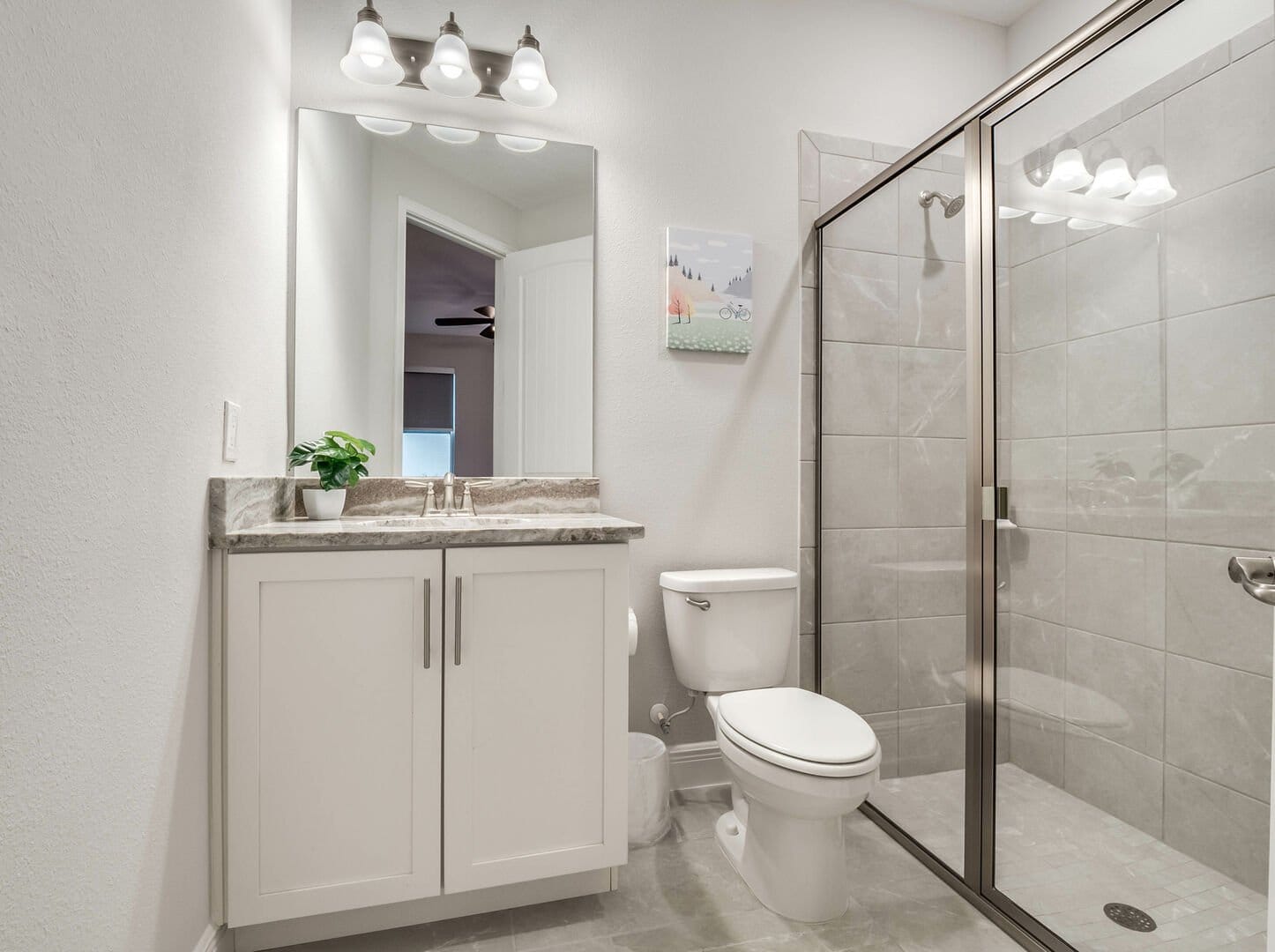 Modern bathroom with shower and vanity.