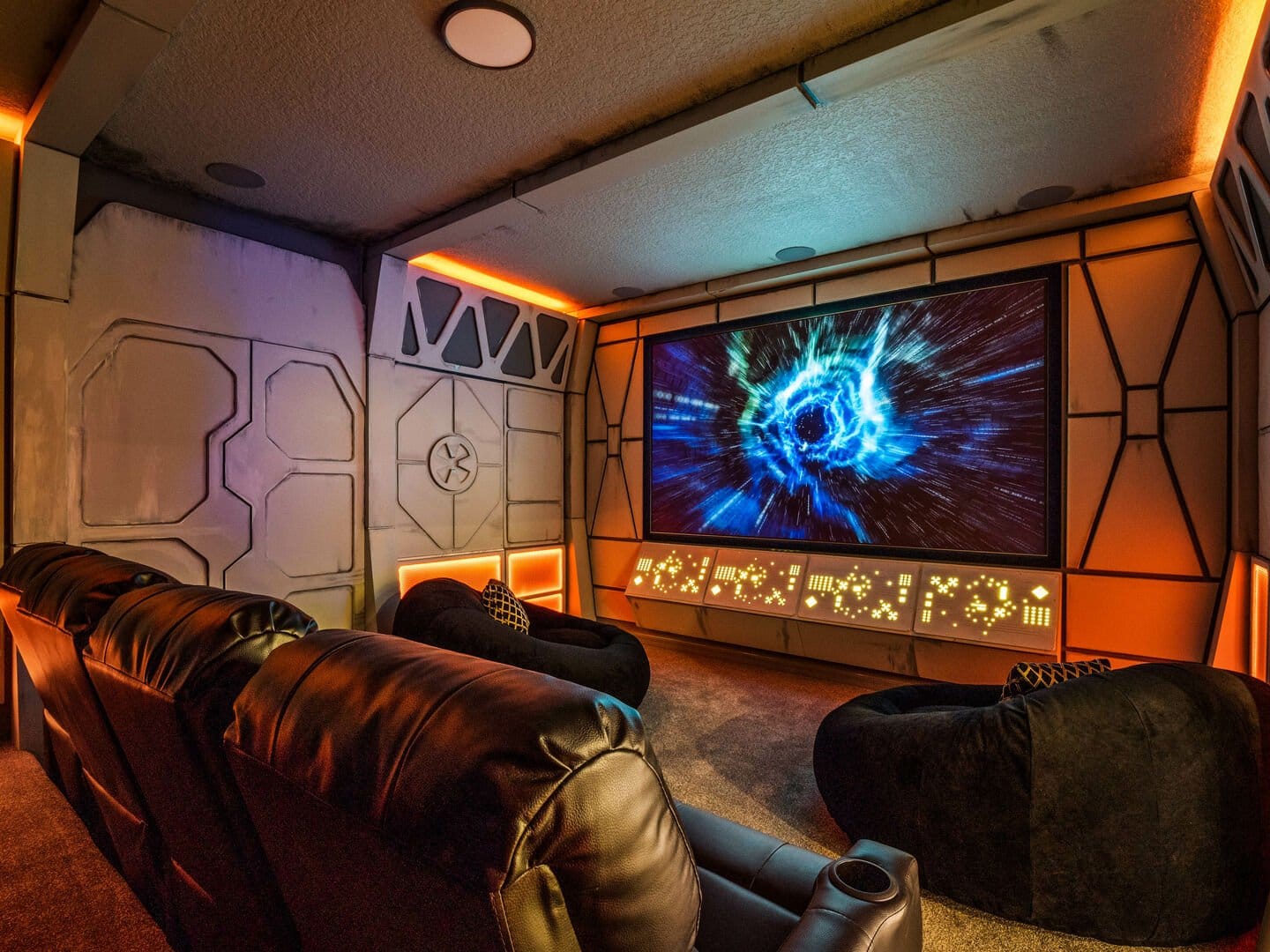 Futuristic home theater with leather chairs.