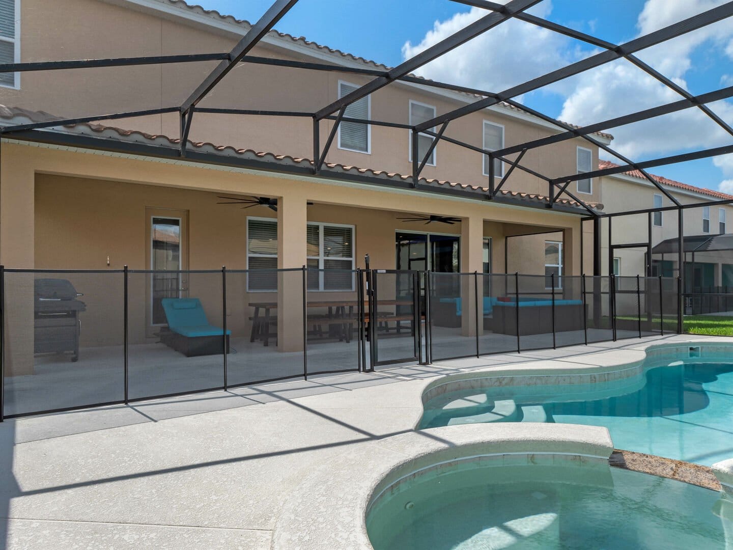 Screen-enclosed pool with adjacent patio.