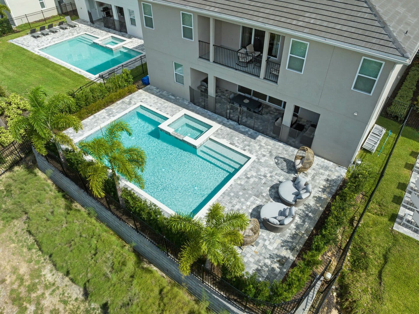 Backyard pool area with seating arrangements.