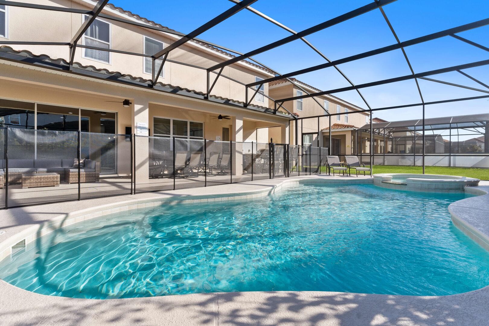 Screened pool area with patio furniture.