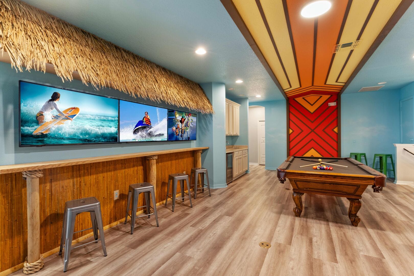 Tropical-themed game room with pool table.