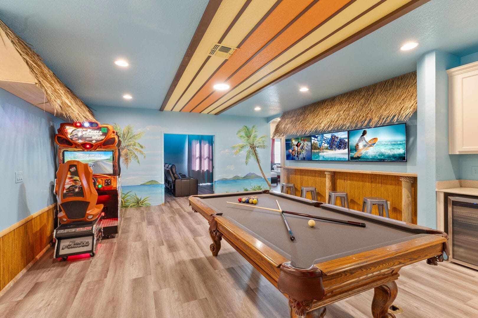 Tropical-themed game room with pool table.