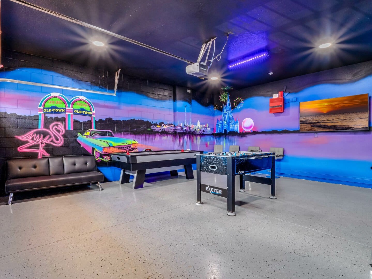 Neon-themed game room with mural.