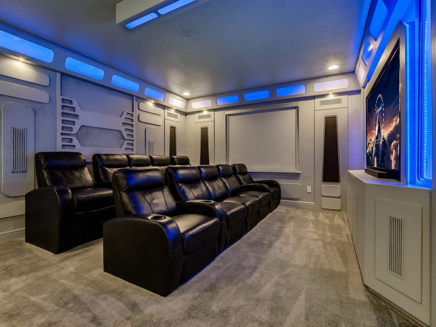 Futuristic home theater with blue lighting.