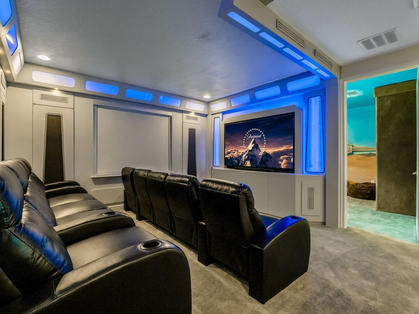 Futuristic home theater with recliners.