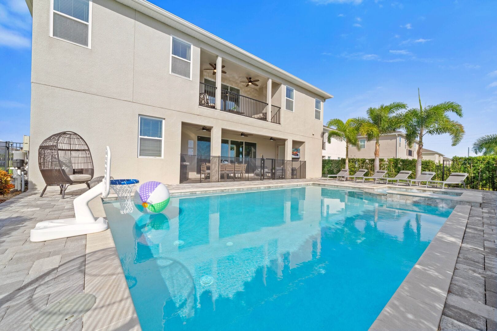 Backyard pool with lounge chairs.