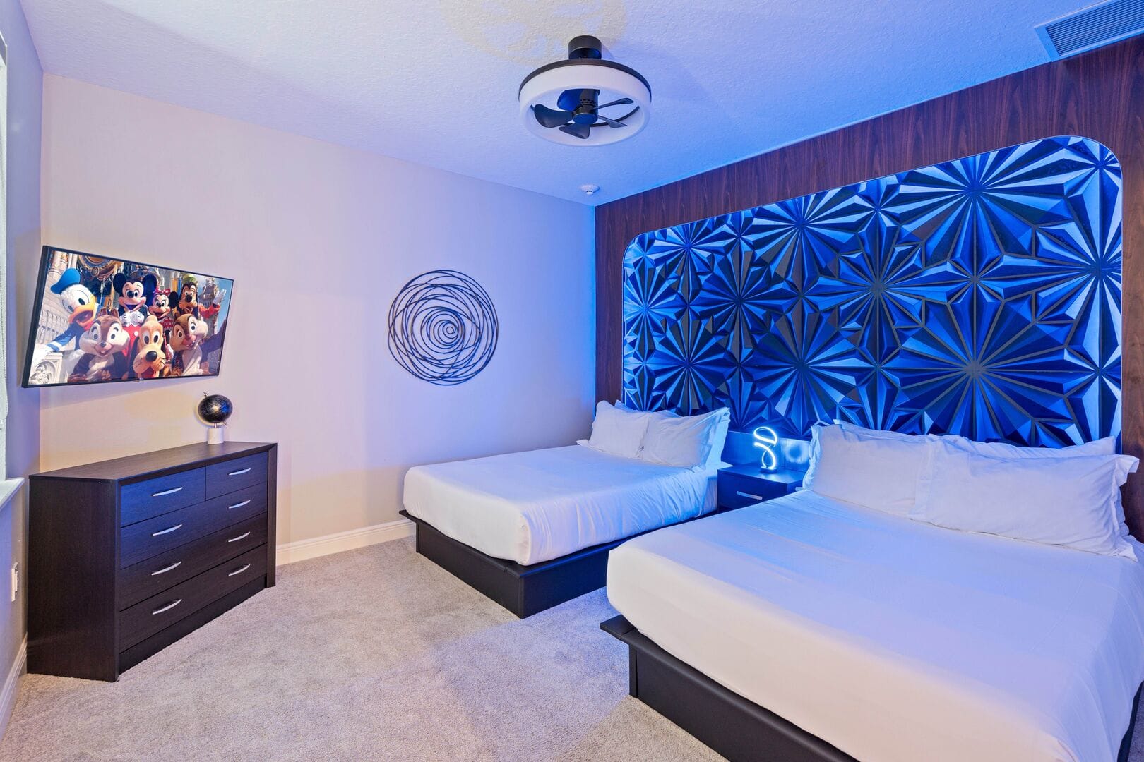 Modern bedroom with blue lighting.