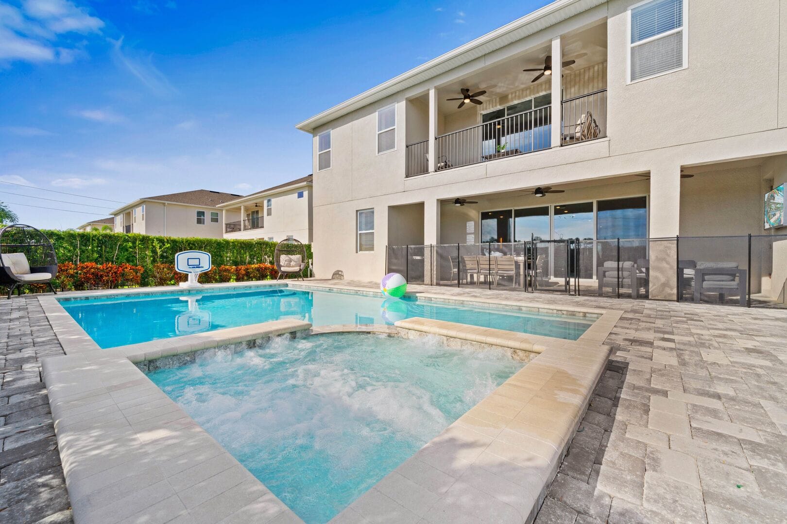 Backyard with pool and seating.