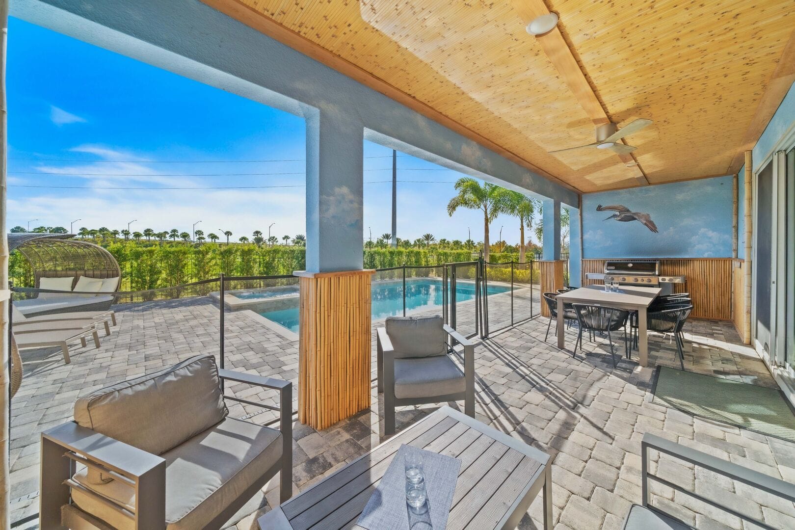 Outdoor patio with pool and furniture.