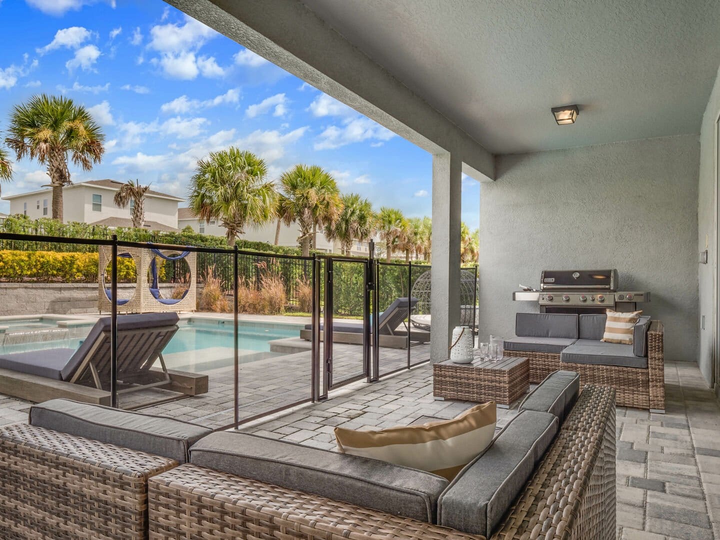 Outdoor patio with pool and furniture.