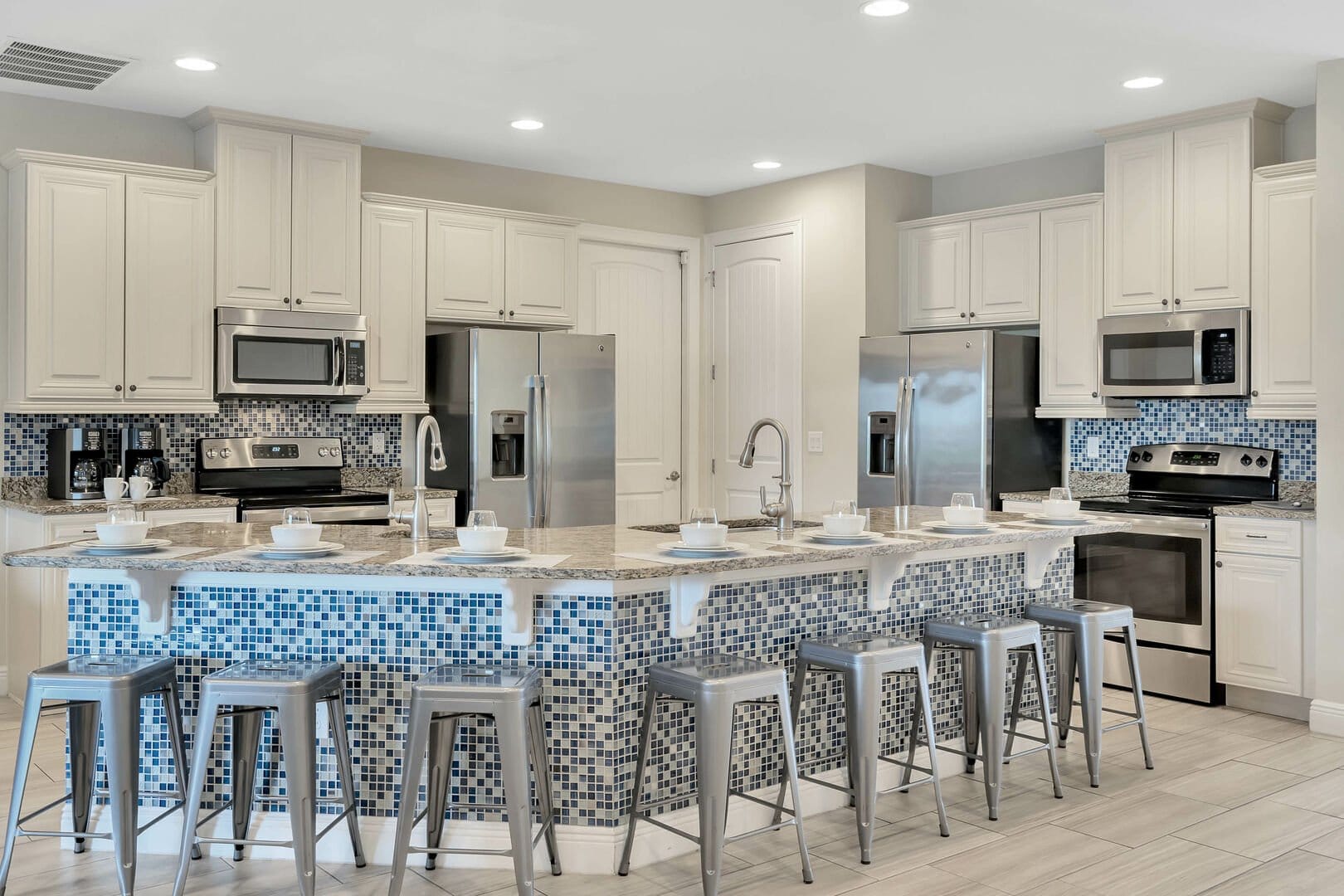 Modern kitchen with island and seating.